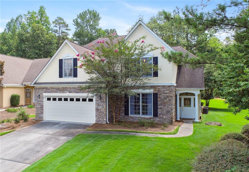 a front view of house with yard and green space