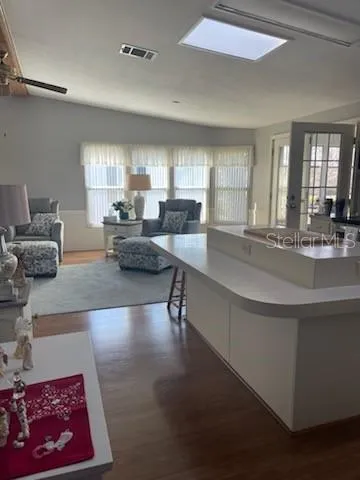 a kitchen with stainless steel appliances kitchen island granite countertop a sink and cabinets