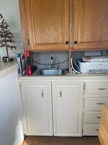 a kitchen with stainless steel appliances a table chairs and a refrigerator