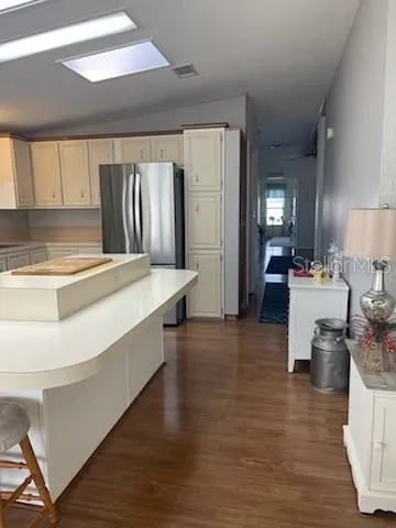 a view of swimming pool with lawn chairs and wooden fence