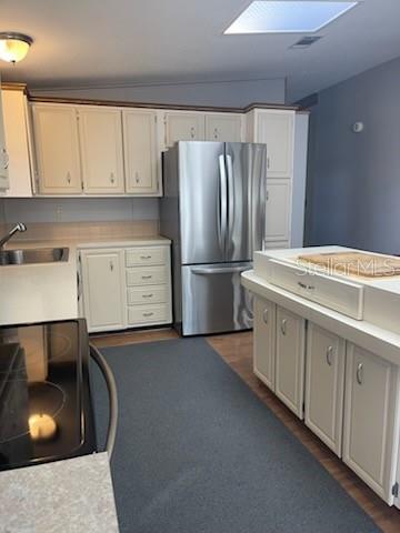 42 Seminole Path Wildwood, FL 34785 - Photo 42 of 59 a kitchen with white cabinets and refrigerator