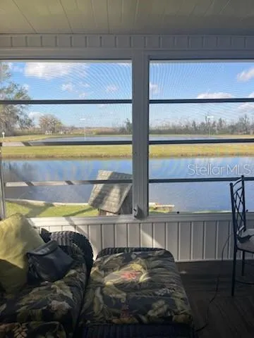 a living room with furniture large window and flat screen tv