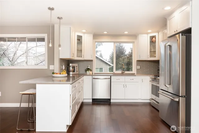 a kitchen with white cabinets and white appliances