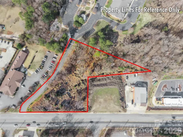 a view of a backyard with wooden fence