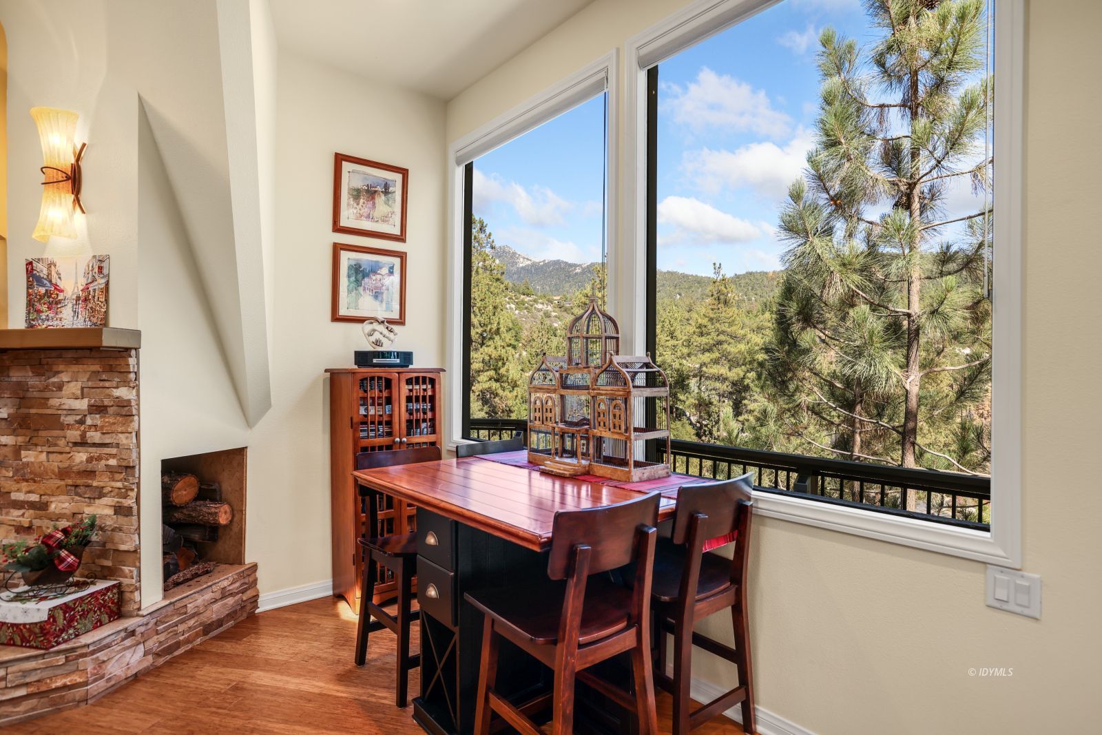 53599 West Ridge Road Idyllwild, CA 92549 - Photo 12 of 49 a dining room with furniture a floor to ceiling window and a fireplace