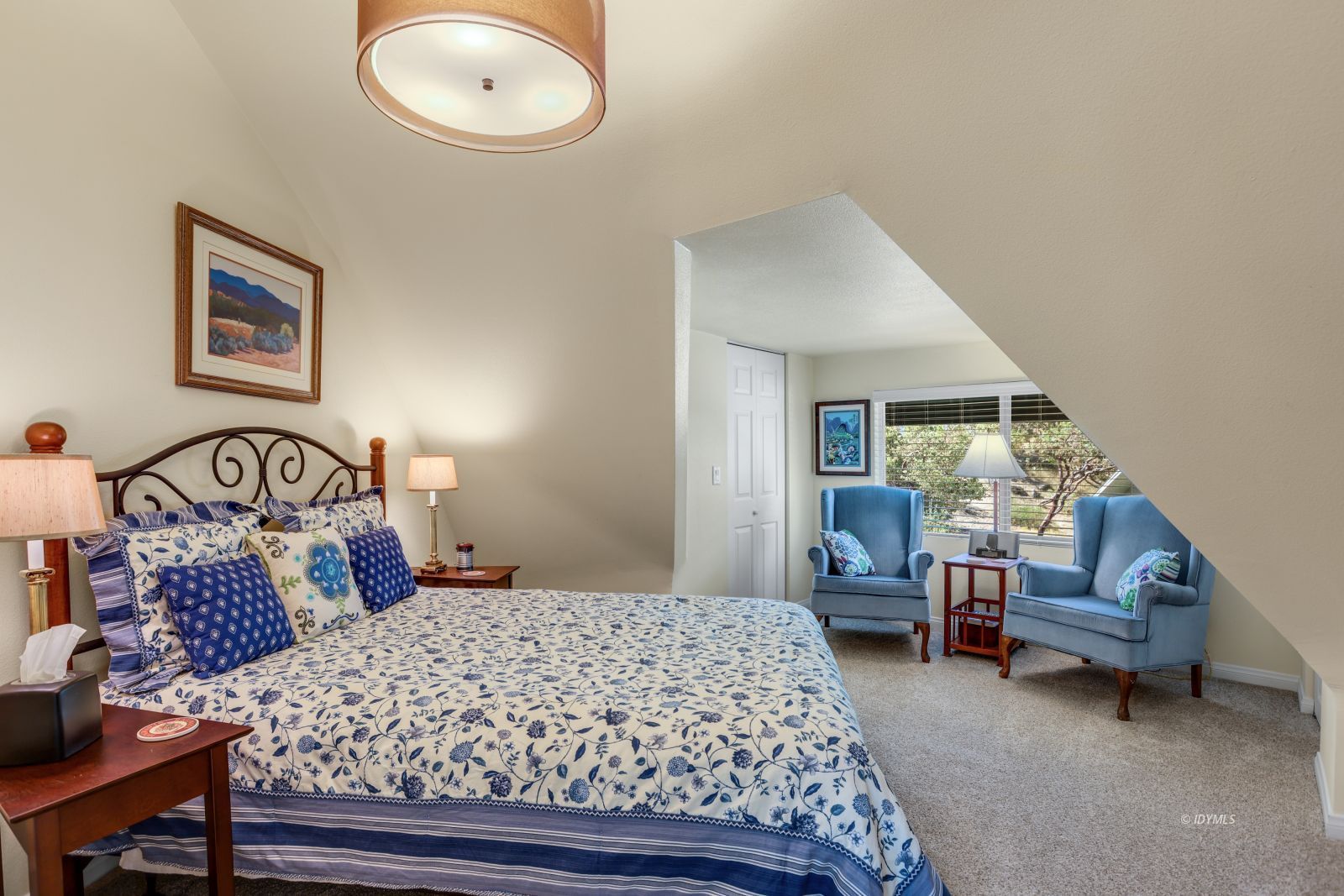 53599 West Ridge Road Idyllwild, CA 92549 - Photo 34 of 49 a bedroom with a bed and a chandelier