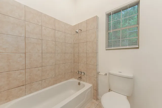 a bathroom with a toilet and bathtub