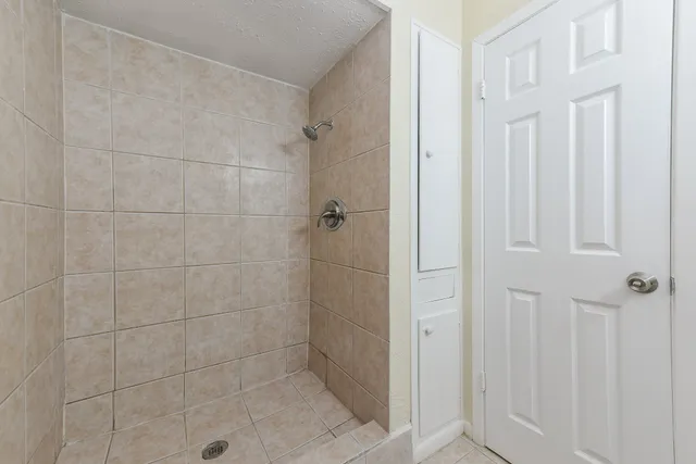 a bathroom with a glass shower door