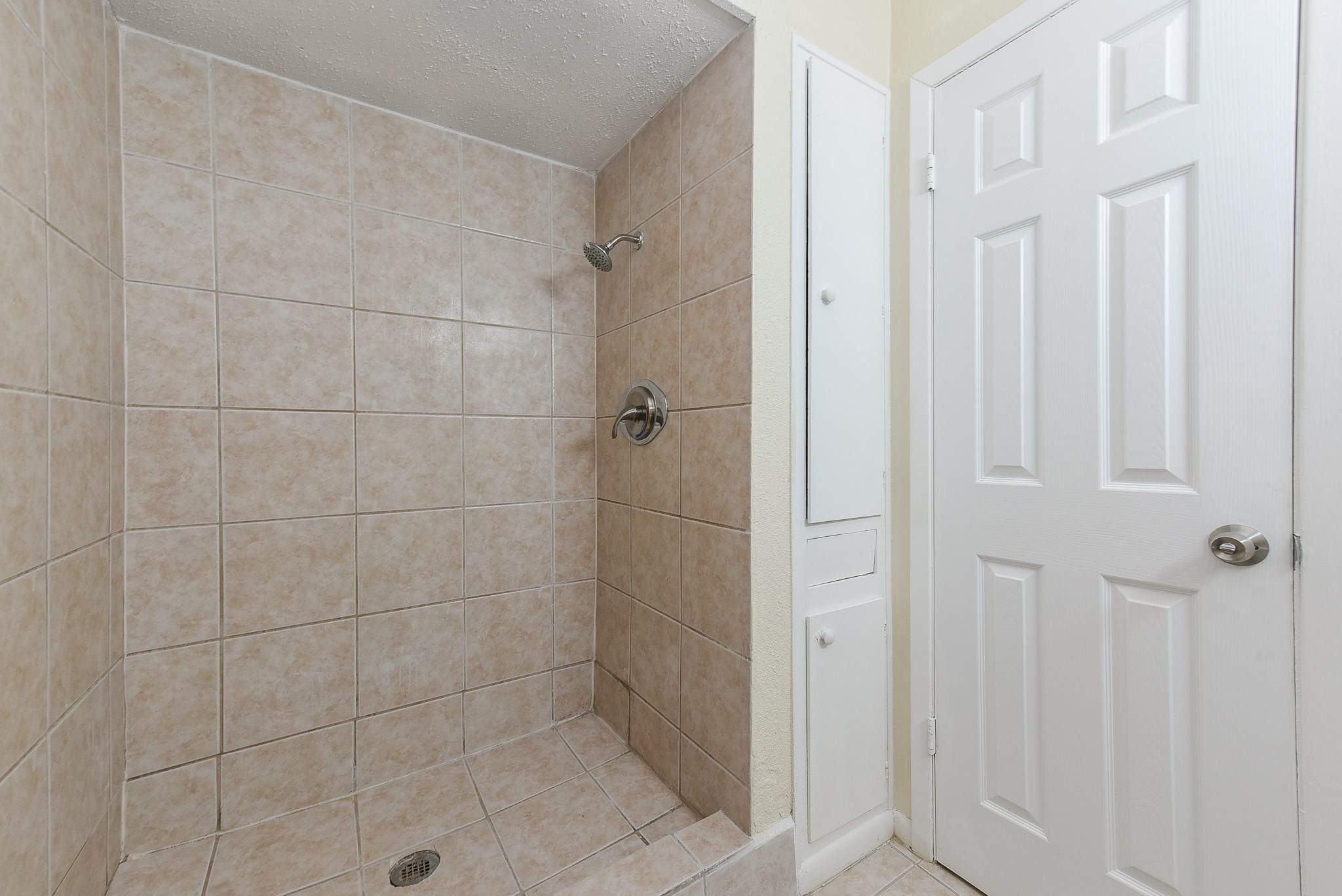18610 Anne Drive Webster, TX 77058 - Photo 33 of 50 a bathroom with a glass shower door