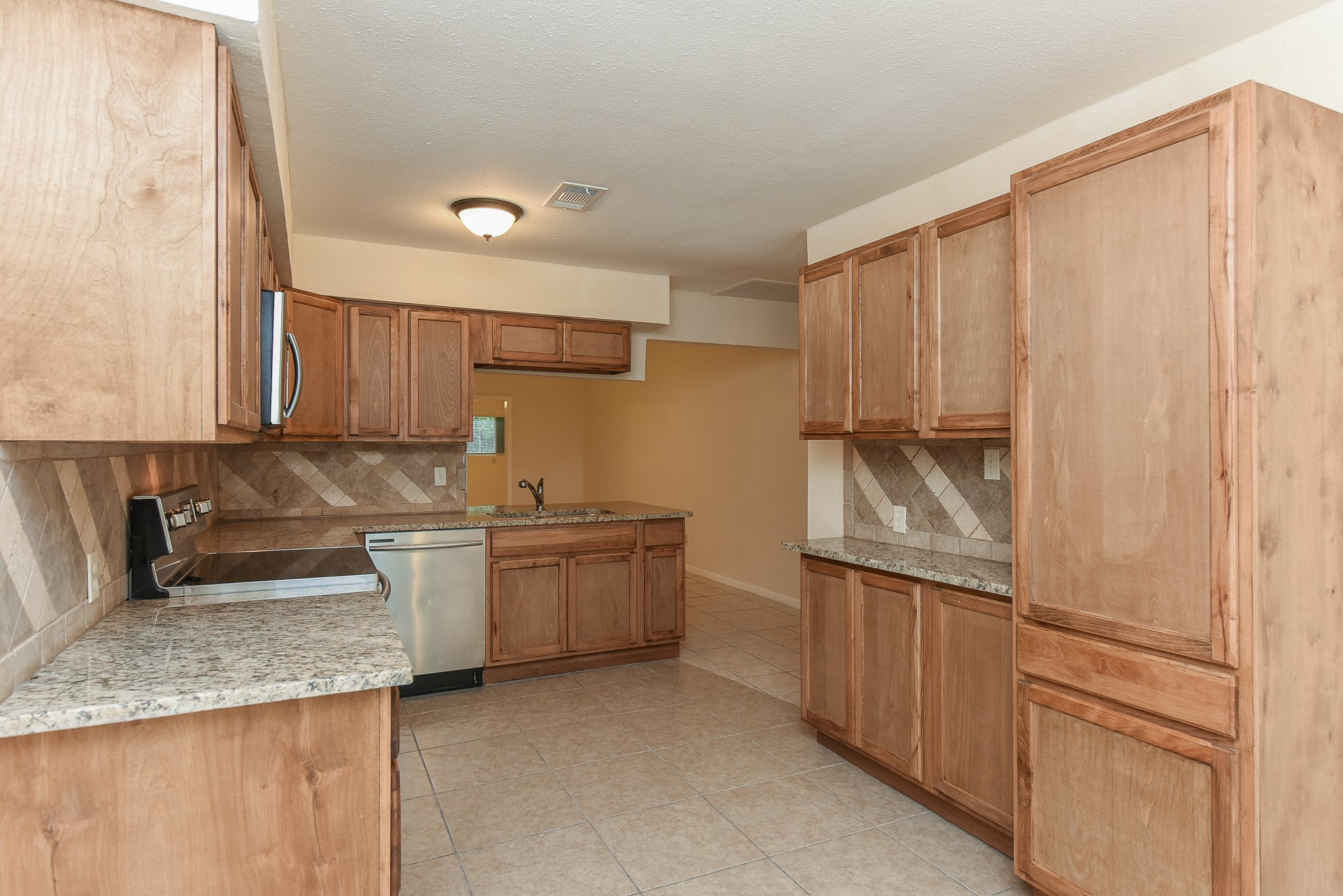 18610 Anne Drive Webster, TX 77058 - Photo 7 of 50 a kitchen with granite countertop a sink and a stove