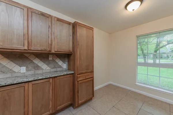 a kitchen with granite countertop a sink and a stove top oven