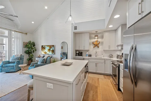 a kitchen with sink refrigerator and microwave