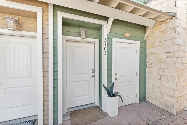 a view of a house with a big yard and potted plants