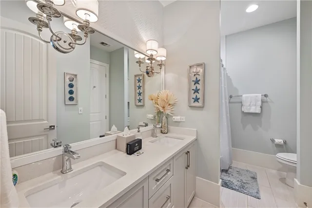a bathroom with a sink double vanity granite and a mirror