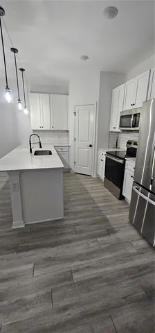 a view of kitchen with sink microwave and stove