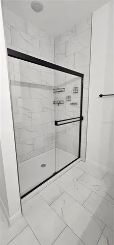 a bathroom with a shower and mirror