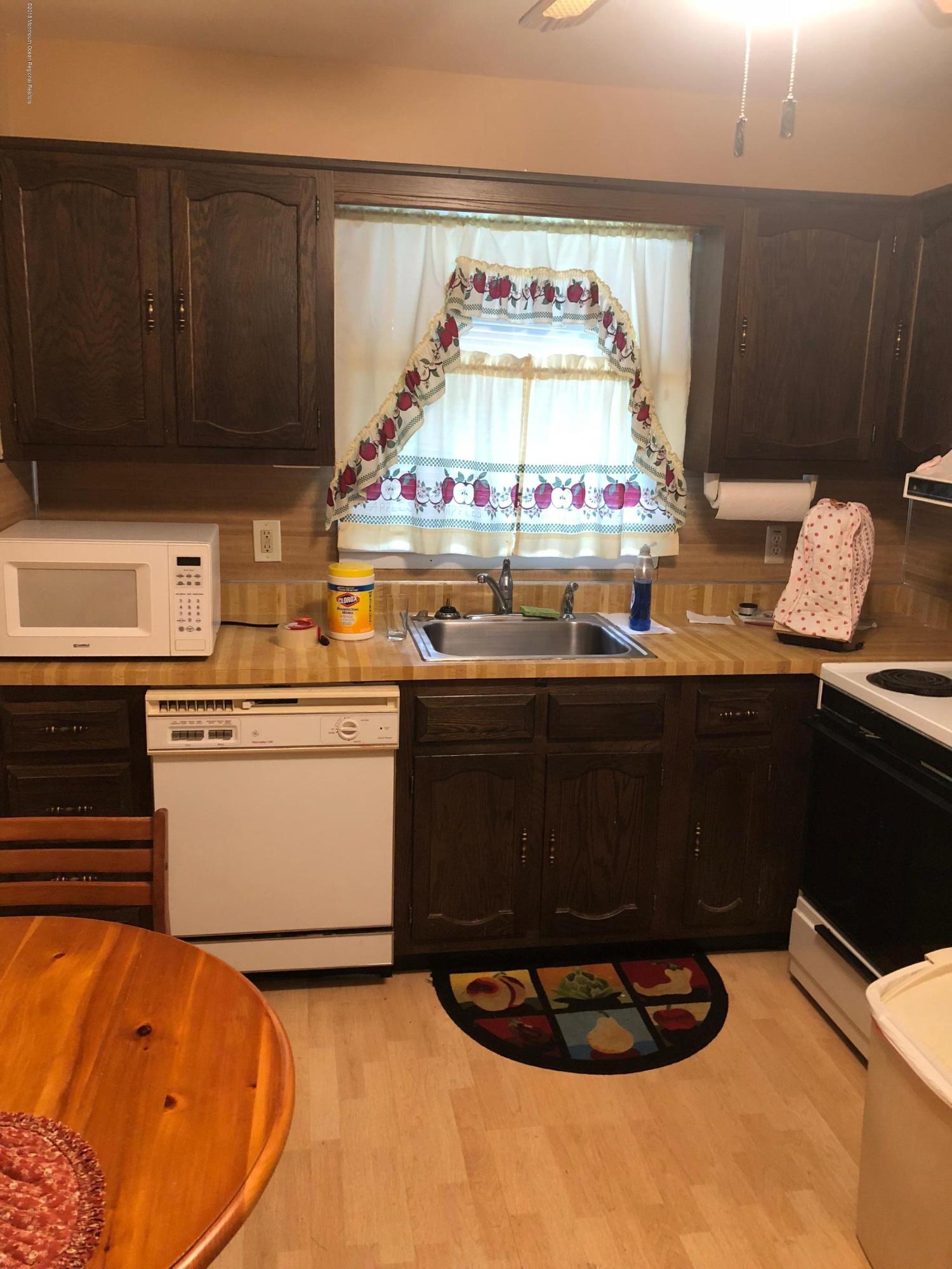 13 A Walnut Road, Unit 15B Manahawkin, NJ 08050 - Photo 4 of 8 a kitchen with a stove and cabinets