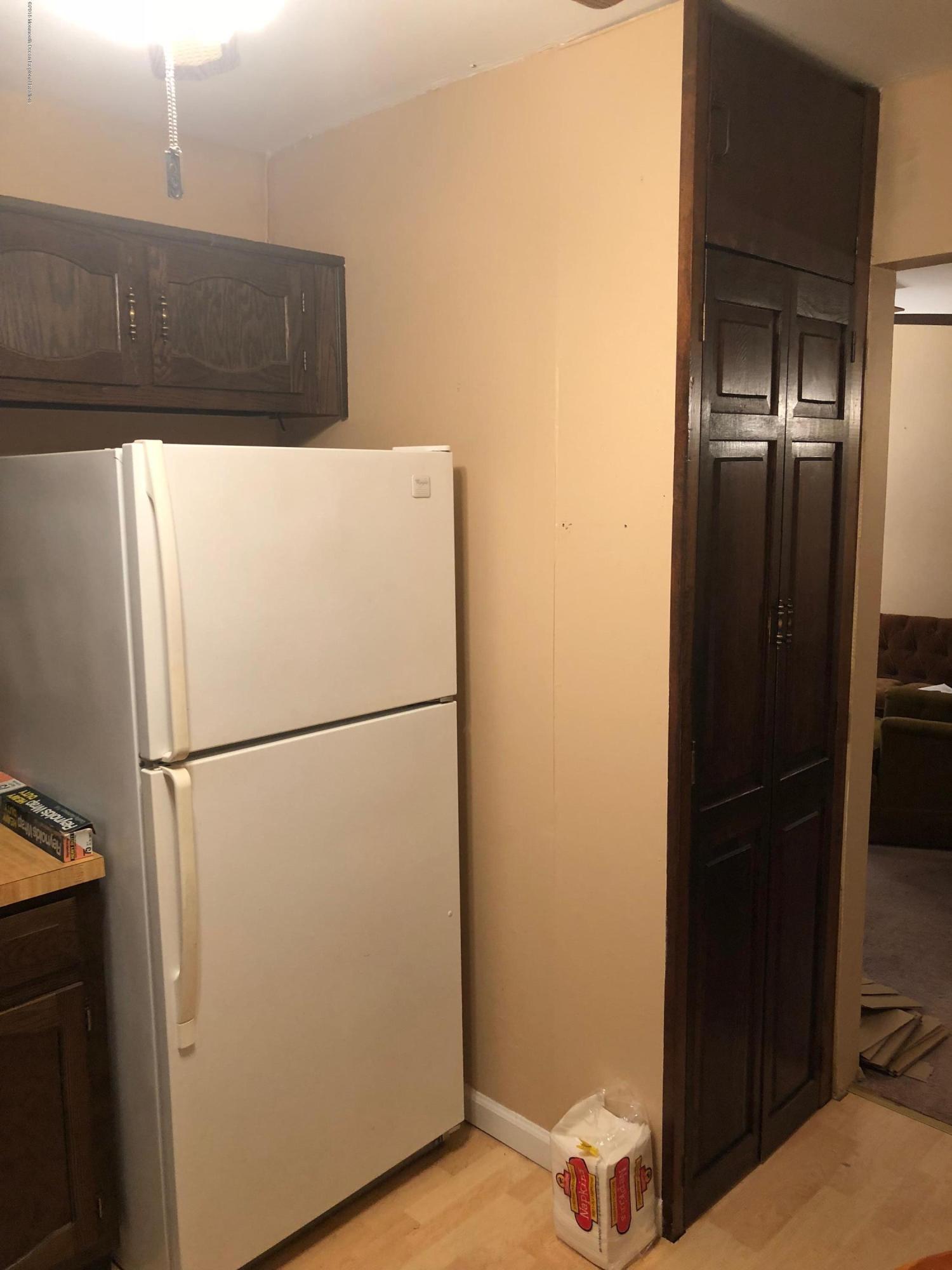 13 A Walnut Road, Unit 15B Manahawkin, NJ 08050 - Photo 5 of 8 a white refrigerator freezer and a microwave oven in a kitchen