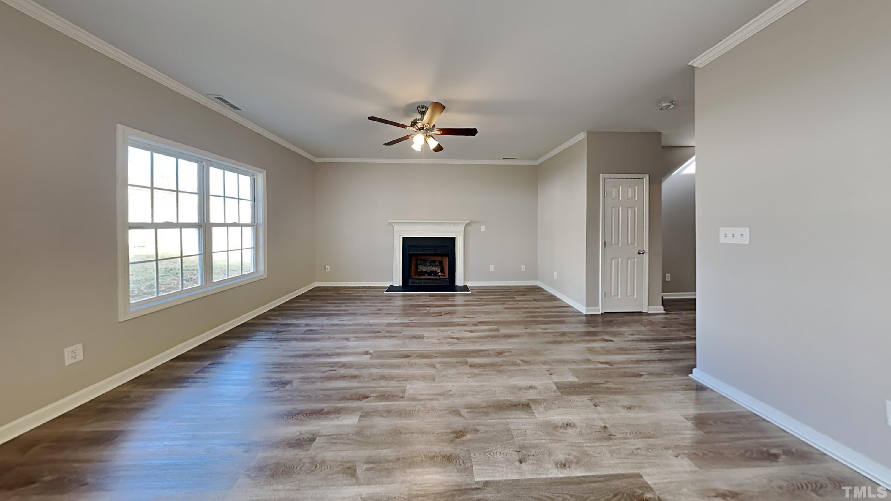 3602 Rendition Street Raleigh, NC 27610 - Photo 3 of 13 wooden floor in an empty room with a fireplace