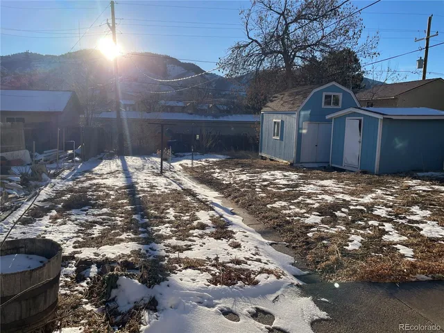 a view of a yard with wooden fence
