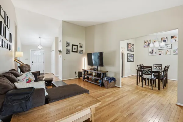 a living room with furniture and wooden floor