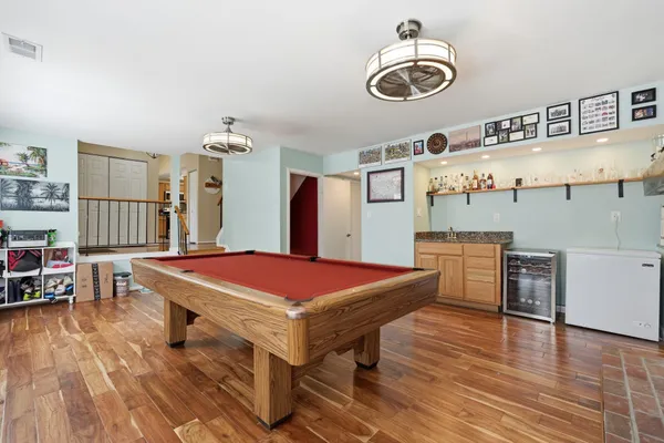 a room with pool table and windows