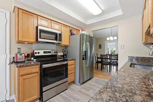 a kitchen with stainless steel appliances granite countertop a stove and a refrigerator