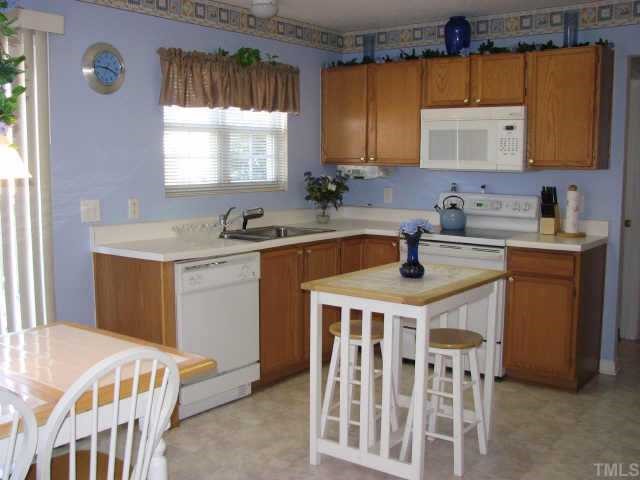 5604 Orchard Gate Way Raleigh, NC 27616 - Photo 6 of 8 a kitchen that has a sink and a stove in it