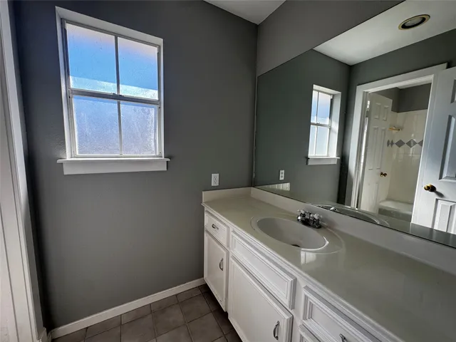 a bathroom with a sink and a window