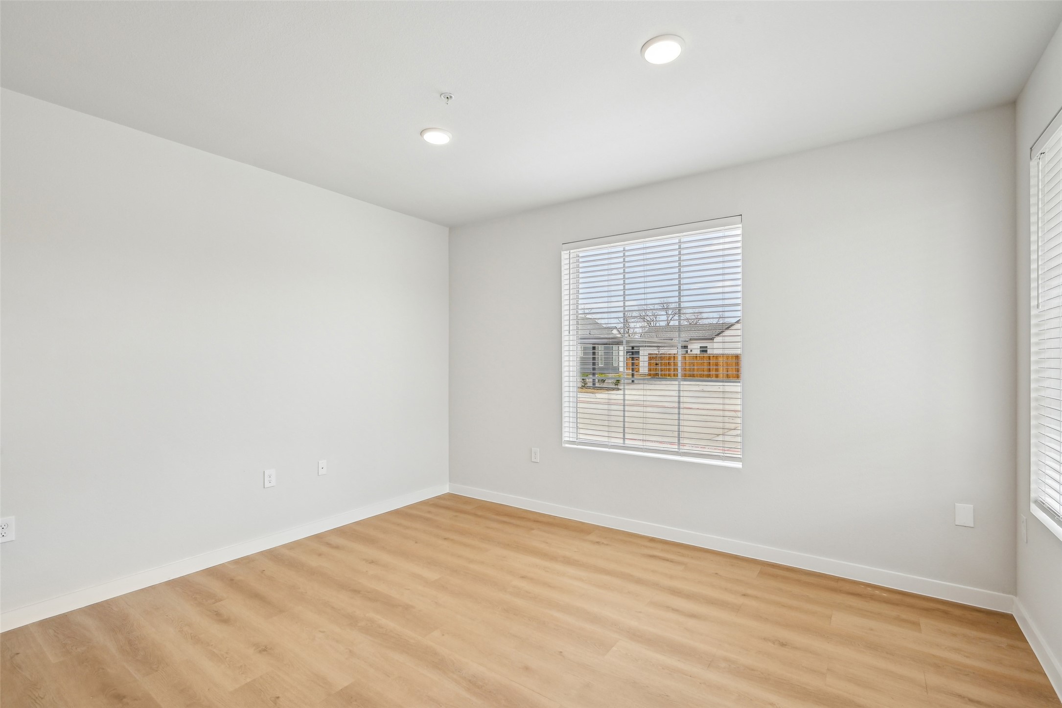 3651-506 South Custer Road McKinney, TX 75070 - Photo 12 of 21 an empty room with wooden floor and windows