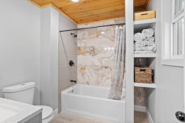 a bathroom with a bathtub and shower