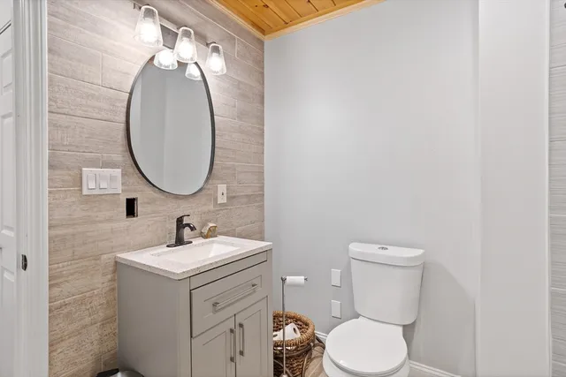 a bathroom with a toilet a sink and a mirror