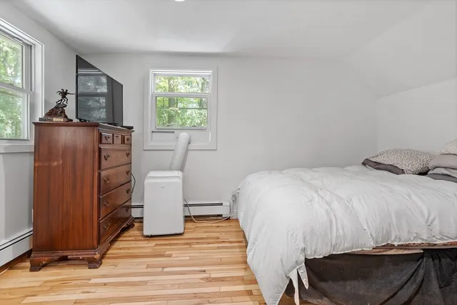 a bedroom with a bed and a window