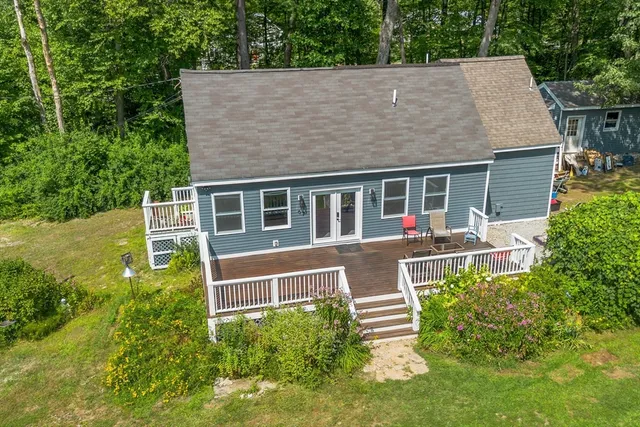 a aerial view of a house with a yard table and chairs
