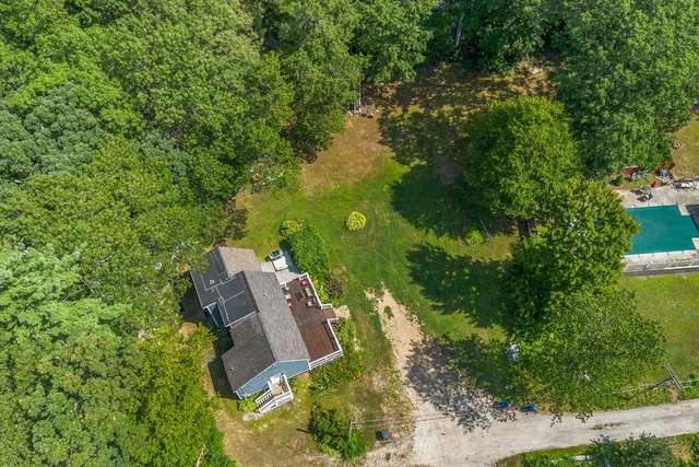 an aerial view of house with yard and outdoor seating