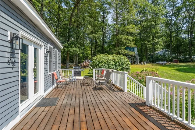a view of balcony with wooden floor and fence