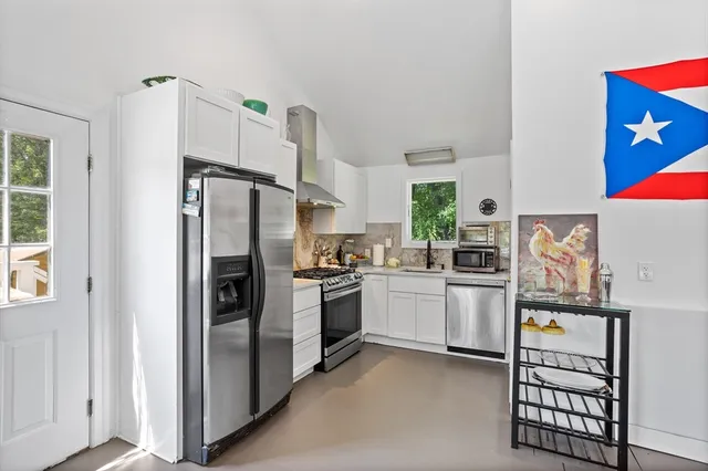 a kitchen with stainless steel appliances a refrigerator sink and stove top oven