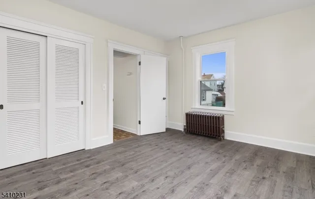 an empty room with window and furniture