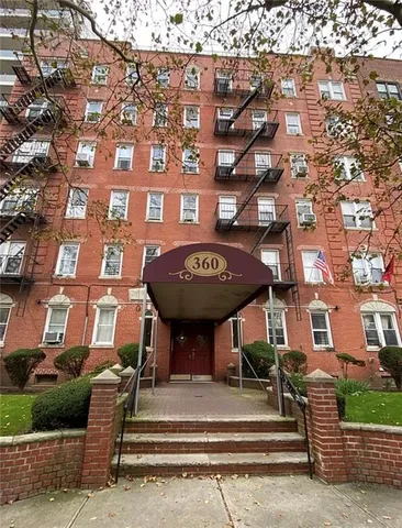 a view of a brick building with a tree