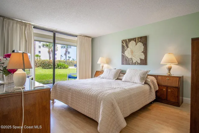 a bedroom with a bed and large window