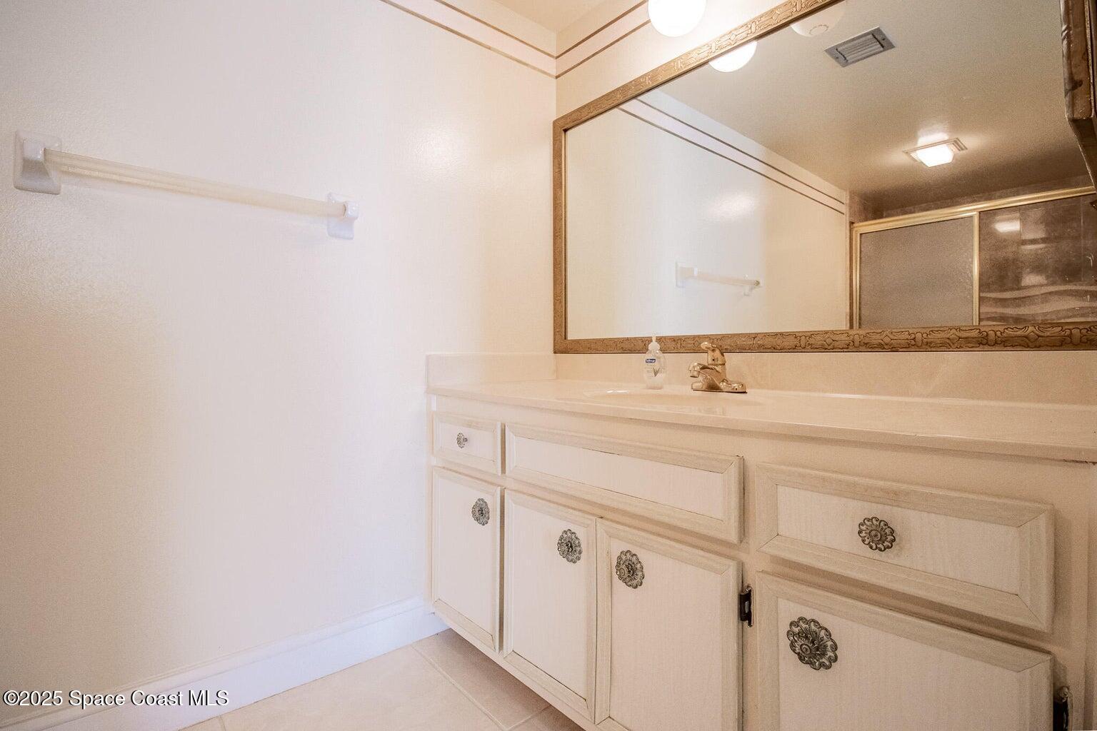 840 North Atlantic Avenue, Unit C103 Cocoa Beach, FL 32931 - Photo 17 of 30 a bathroom with a sink and a mirror