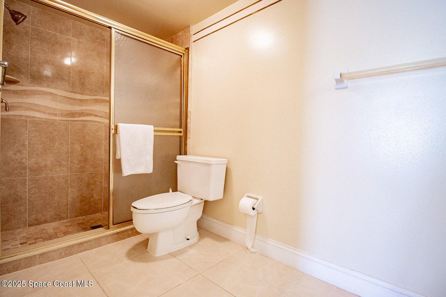 840 North Atlantic Avenue, Unit C103 Cocoa Beach, FL 32931 - Photo 18 of 30 a bathroom with a toilet and a shower