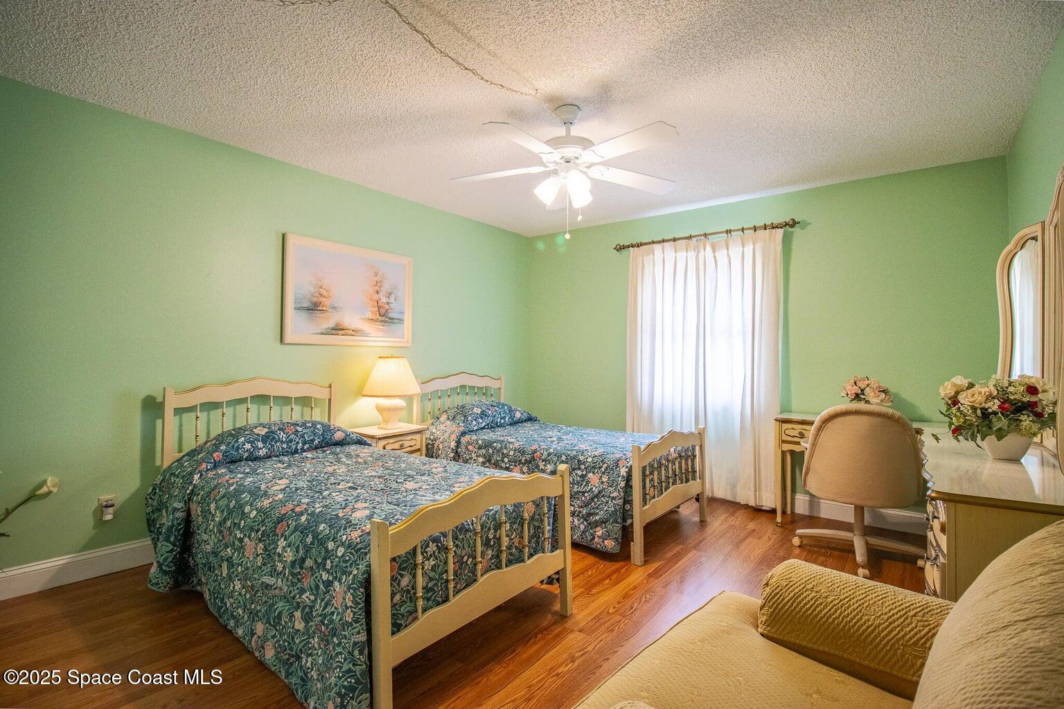 840 North Atlantic Avenue, Unit C103 Cocoa Beach, FL 32931 - Photo 19 of 30 a bedroom with a bed and a chandelier