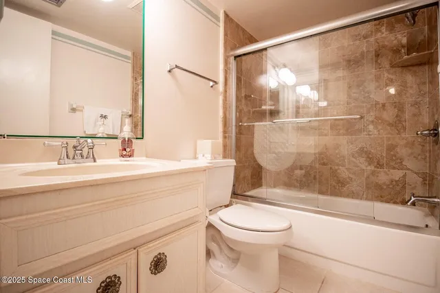 a bathroom with a bathtub shower sink vanity and toilet