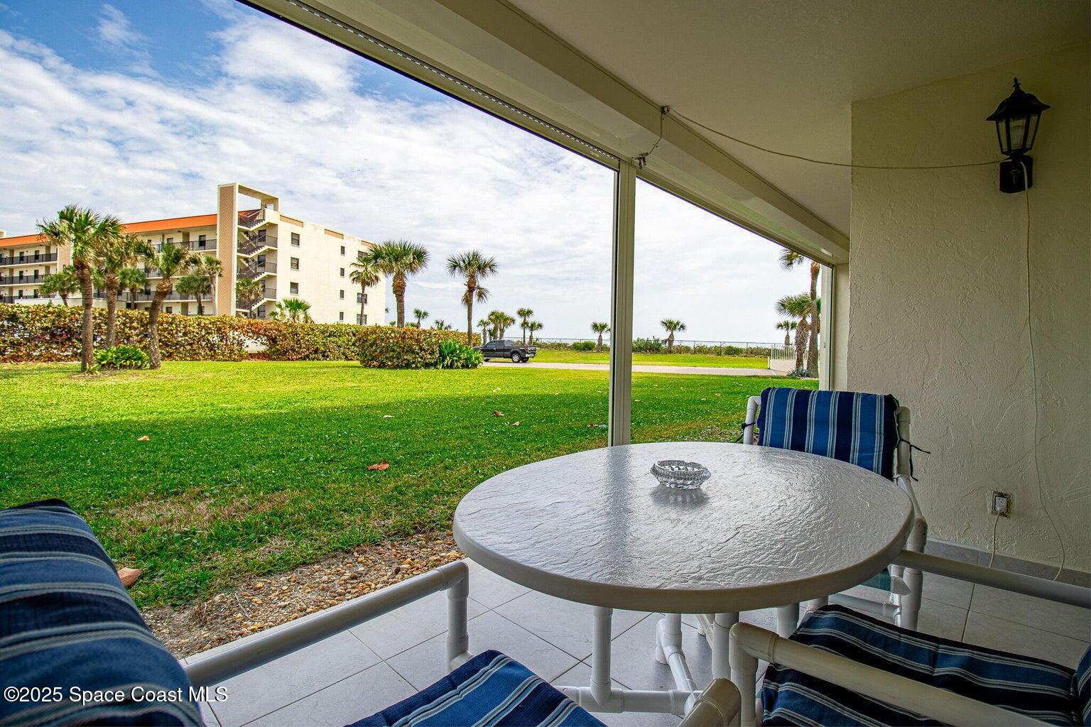 840 North Atlantic Avenue, Unit C103 Cocoa Beach, FL 32931 - Photo 21 of 30 a view of a chairs and table in the balcony