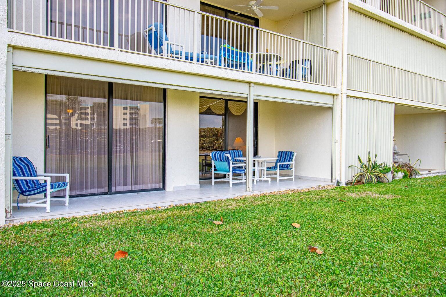 840 North Atlantic Avenue, Unit C103 Cocoa Beach, FL 32931 - Photo 22 of 30 a view of a house with a yard and sitting area