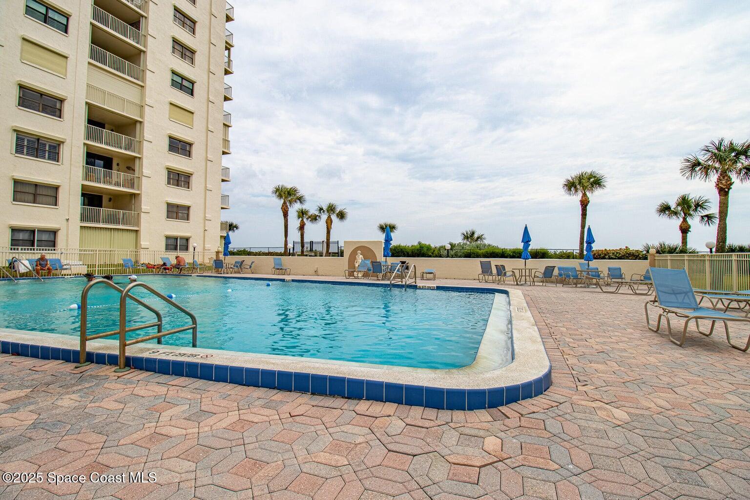 840 North Atlantic Avenue, Unit C103 Cocoa Beach, FL 32931 - Photo 24 of 30 a view of a swimming pool with a yard