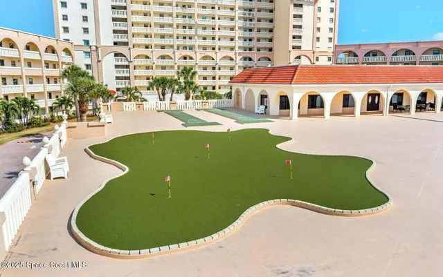 a view of a swimming pool with outdoor seating