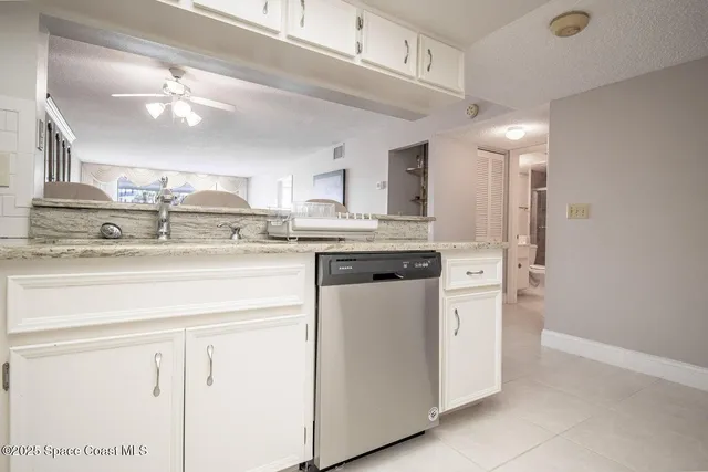 a kitchen with kitchen island a stove a sink and a refrigerator with wooden floor