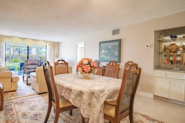 a view of a dining room with furniture and a large window
